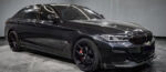 Black luxury SUV with tinted windows and sporty black rims.