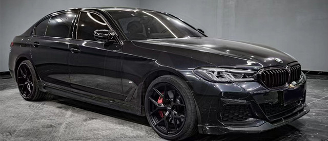 Black luxury SUV with tinted windows and sporty black rims.