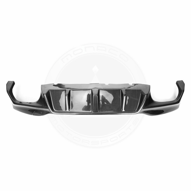 Black car rear bumper with integrated exhaust cutouts.