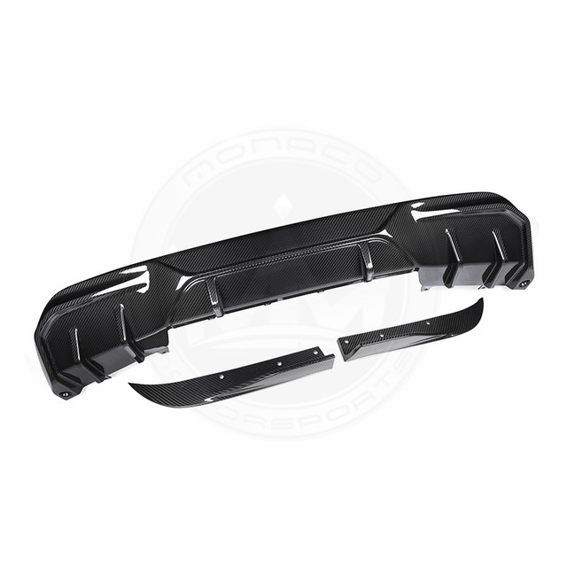 Black car rear diffuser with aerodynamic fins and a chrome accent.