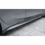 Close-up of a car's side skirt on a gray vehicle.