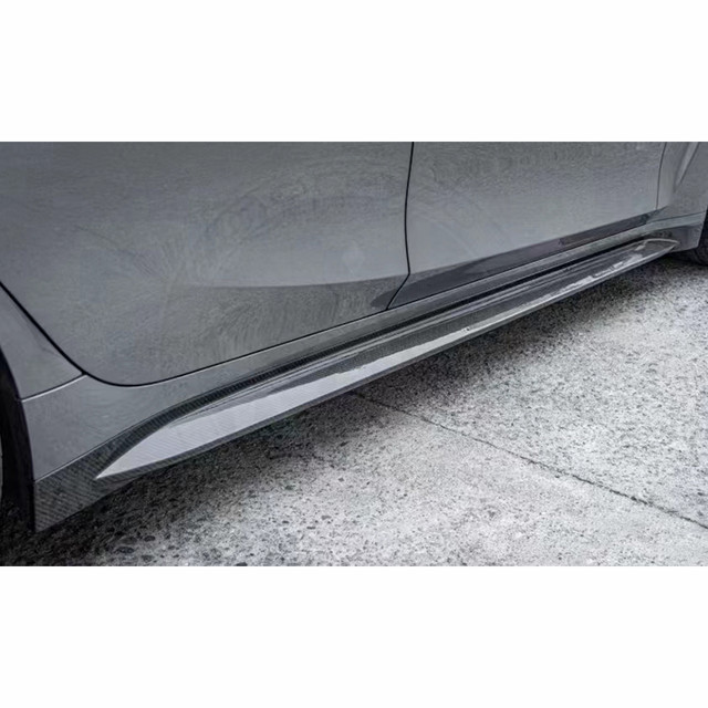 Close-up of a car's side skirt on a gray vehicle.